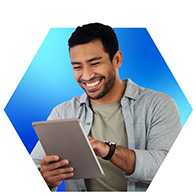 Smiling man using a tablet, representing reliable 400 Mbps internet for HD streaming and everyday online activity.