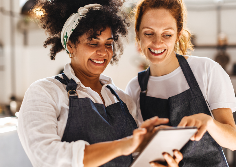 Two woman looking at a tablet