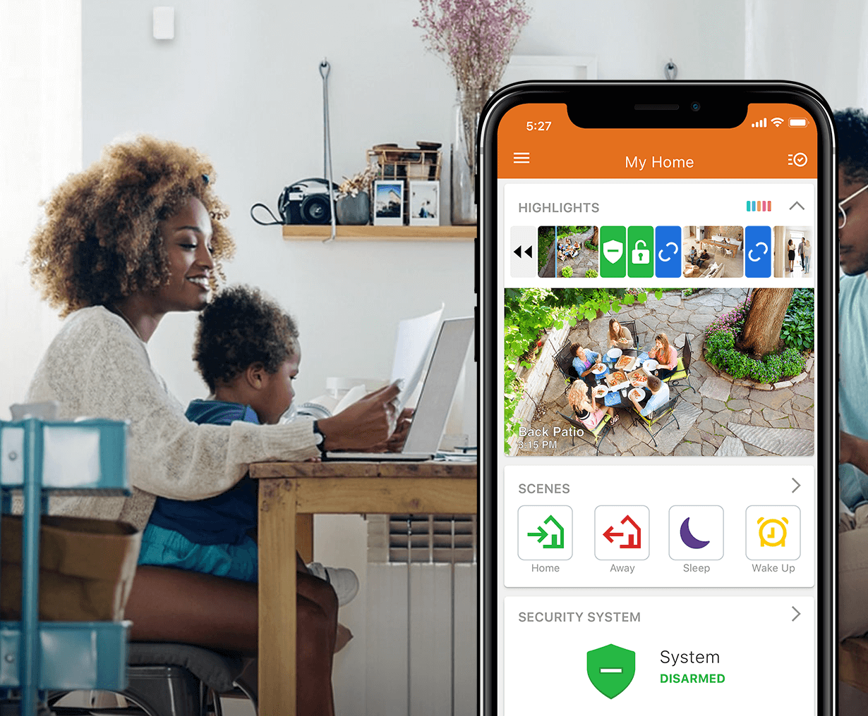 Mom with son at a table using my home on alarm.com app